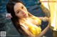 A woman in a yellow dress in the water.