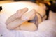 A woman laying on a bed with her feet up.