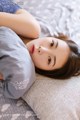 A woman laying on a bed with a pillow.