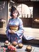 A woman in a kimono sitting on a wooden deck.