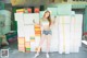 A woman standing in front of a pile of boxes.